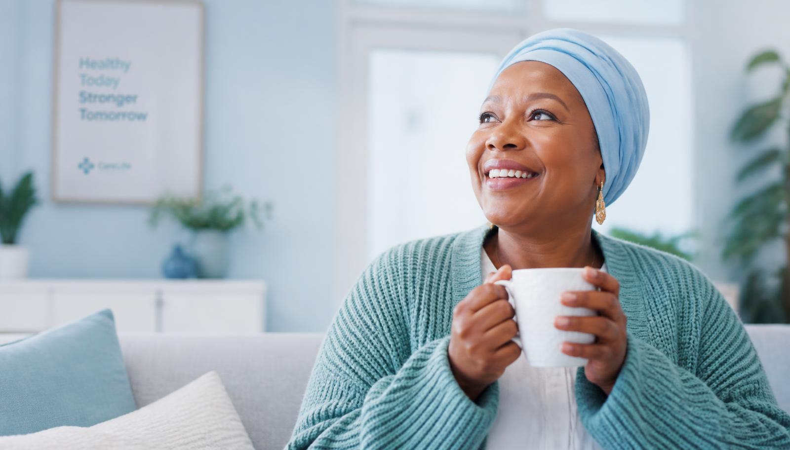 Smiling woman at home holding a mug, feeling well after receiving her medicines